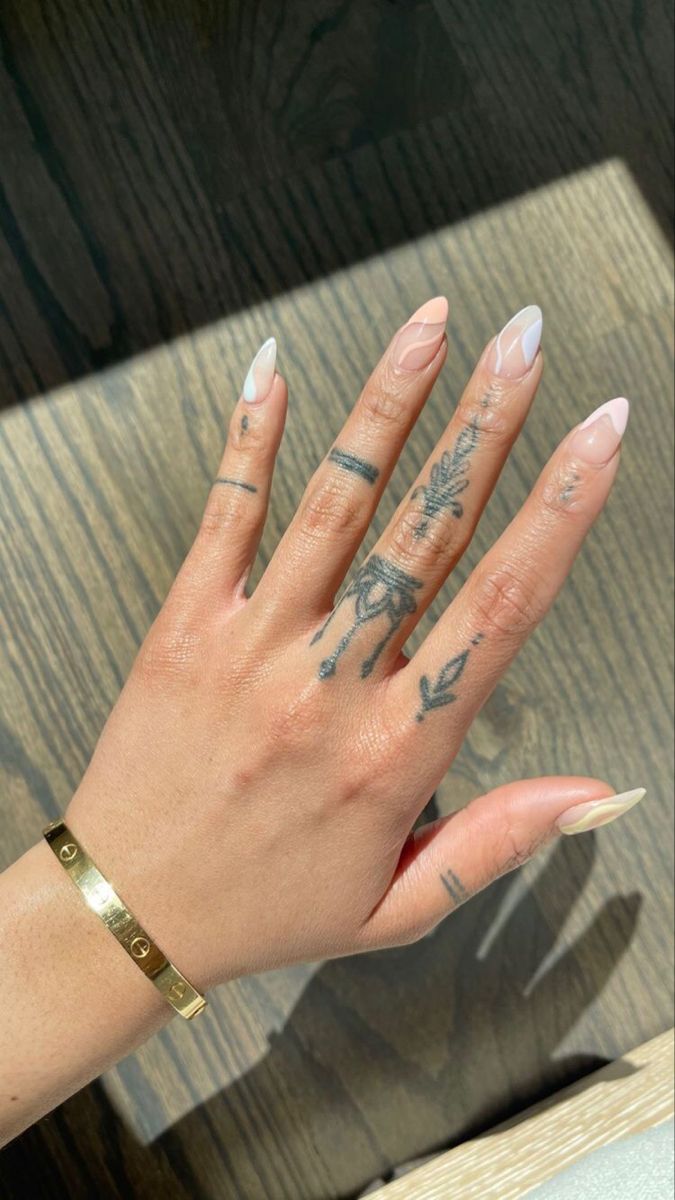 a woman's hand with tattoos on it