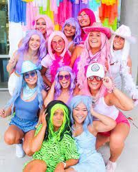 a group of women dressed in costumes posing for a photo