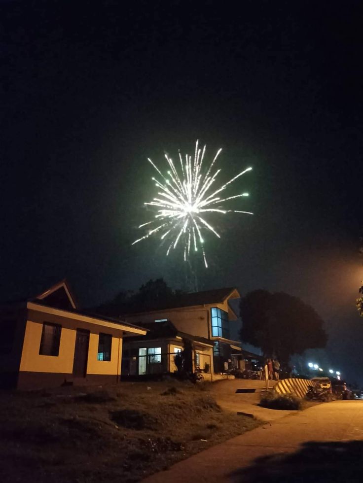 fireworks in the night sky above a building