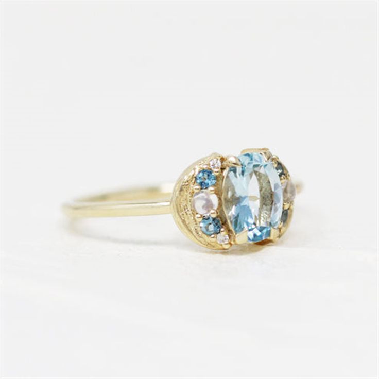 Discover the unique charm of the LeConte Impasto Collection with this handcrafted 14K yellow gold artisan fashion ring, size 6. Designed for those who appreciate the beauty of art and nature, this exquisite piece features a central 0.97ct oval aquamarine, enveloped by an array of stunning gemstones.Key Features:-Exceptional Craftsmanship: Each ring is a masterpiece from the LeConte Impasto Collection, reflecting the pinnacle of artisanal skill.-Captivating Centerpiece: A mesmerizing 0.97ct oval Unique Oval Yellow Gold Topaz Ring, Unique Yellow Gold Oval Moonstone Ring, Unique Oval Yellow Gold Moonstone Ring, 14k Gold Celestial Oval Rings, Unique Oval Moonstone Ring In Yellow Gold, Blue Oval Moonstone Ring In 14k Gold, Handmade Oval Sapphire Ring In 14k Gold, Unique Oval Cluster Ring In Yellow Gold, Celestial Oval Yellow Gold Rings