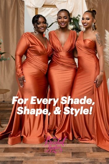 three women in orange dresses posing for the camera