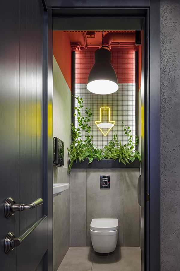 an open door leading to a bathroom with a plant growing on the wall above the toilet