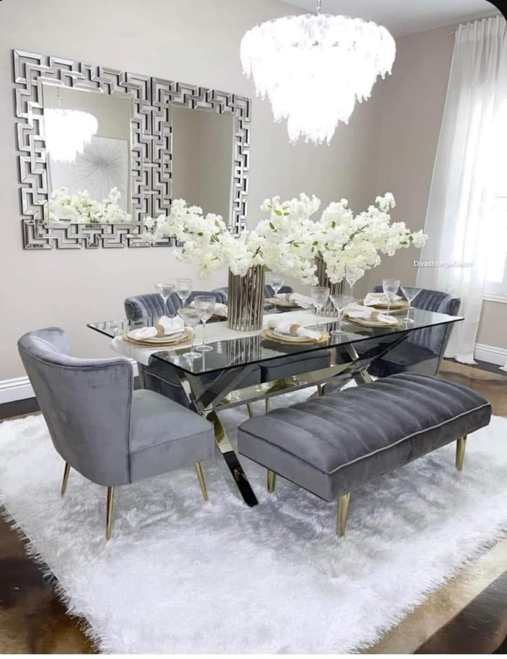 a dining room table with chairs and a bench in front of a mirror on the wall