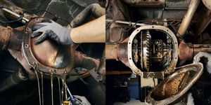 the inside of an industrial machine being worked on by someone with gloves and other tools