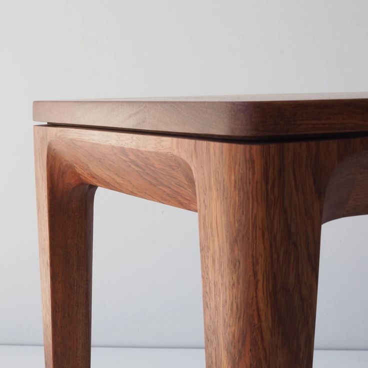 a wooden table sitting on top of a white floor