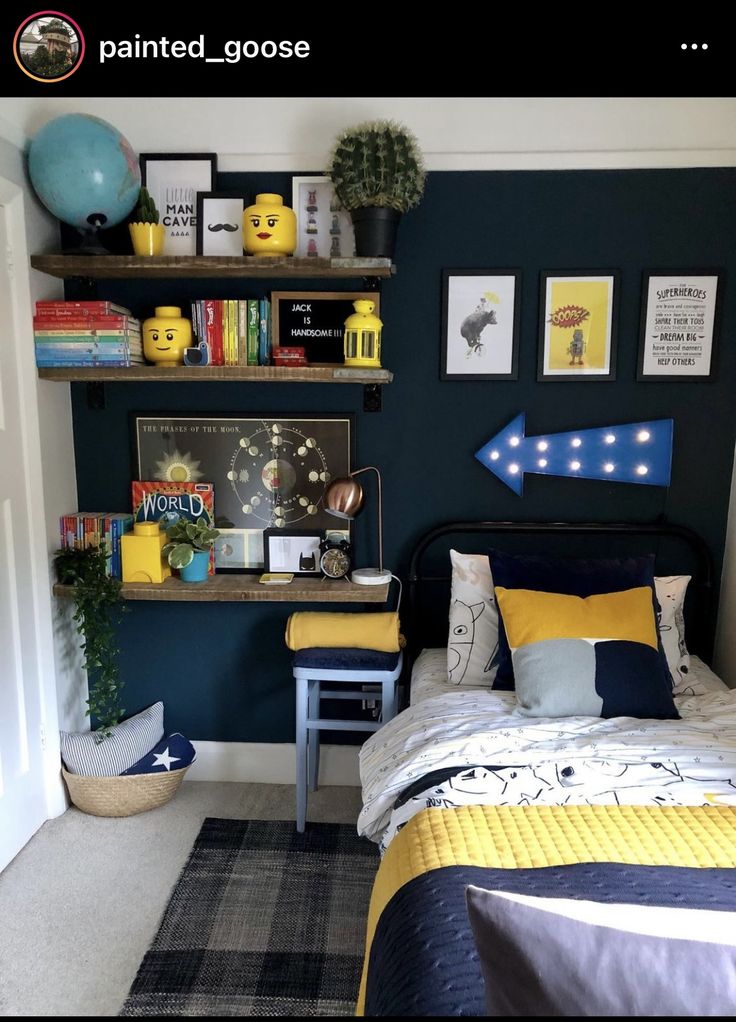 a bedroom decorated in blue and yellow with bookshelves on the wall above the bed