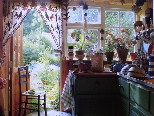 a kitchen filled with lots of pots and pans on top of a counter next to a window