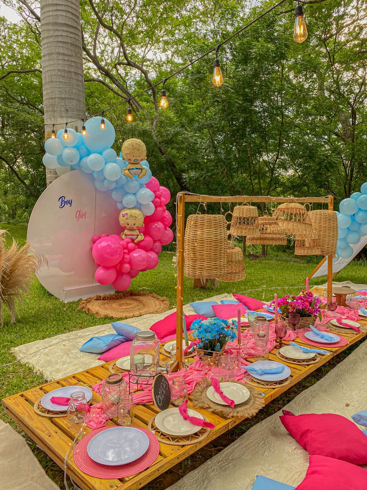 a table set up with balloons and plates