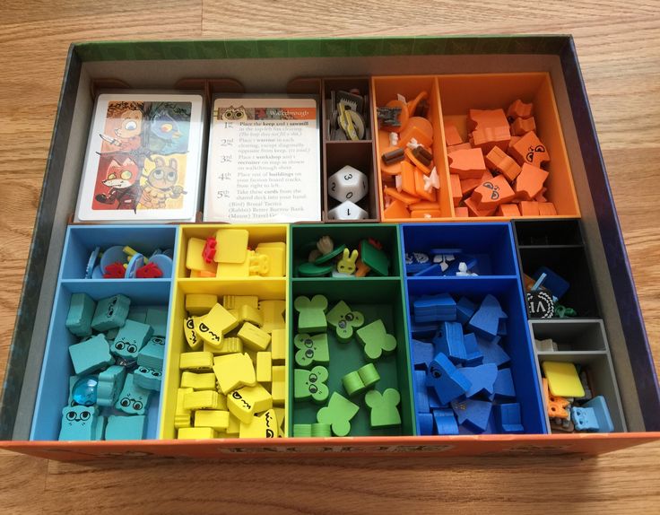 a box filled with lots of different colored plastic blocks and magnets on top of a wooden table