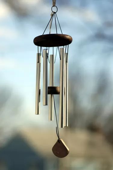 a wind chime hanging from the side of a window