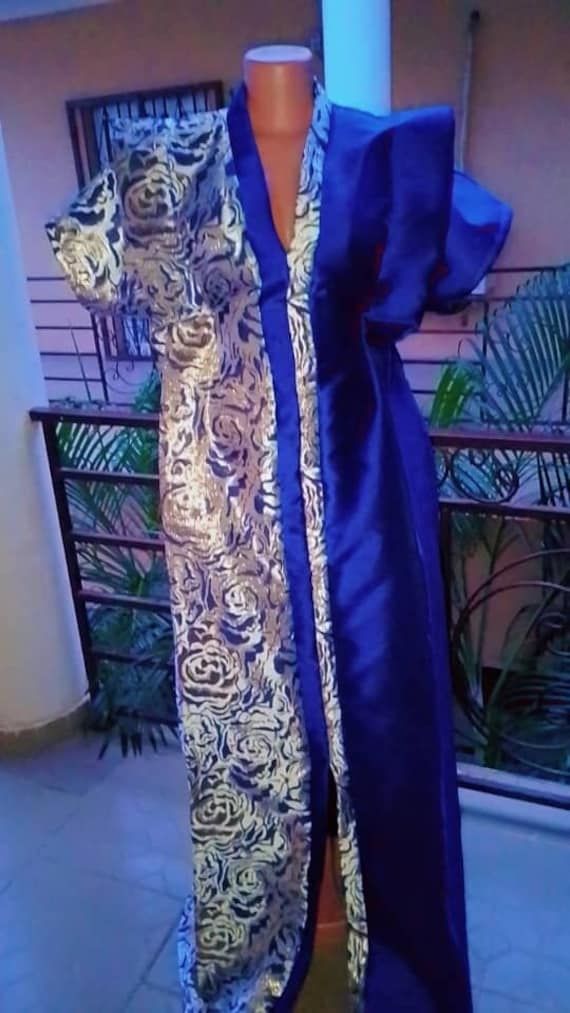 Full length free size blue damask/mikado half'n'half maxi bubu with front slit for uk size 10-14, length 70". Half'n'half female agbada design with a free braided turban in blue mikado fabric. Suitable for formal parties and occasions. Fabric: top quality damask and bridal mikado fabric, machine washable at 30oC. All AfroClassy outfits are made by talented fashion designers in Nigeria, West Africa and dispatched by a UK small business. Style suggestions: Suitable for day or night outing, photoshoots, African bridal outfits, gifts to special women. *Colours may vary depending on your computer screen. Damask Dress Styles Nigeria, Night Outing, Agbada Design, Mikado Fabric, Damask Dress, Formal Parties, African Traditional Dresses, Business Style, West Africa