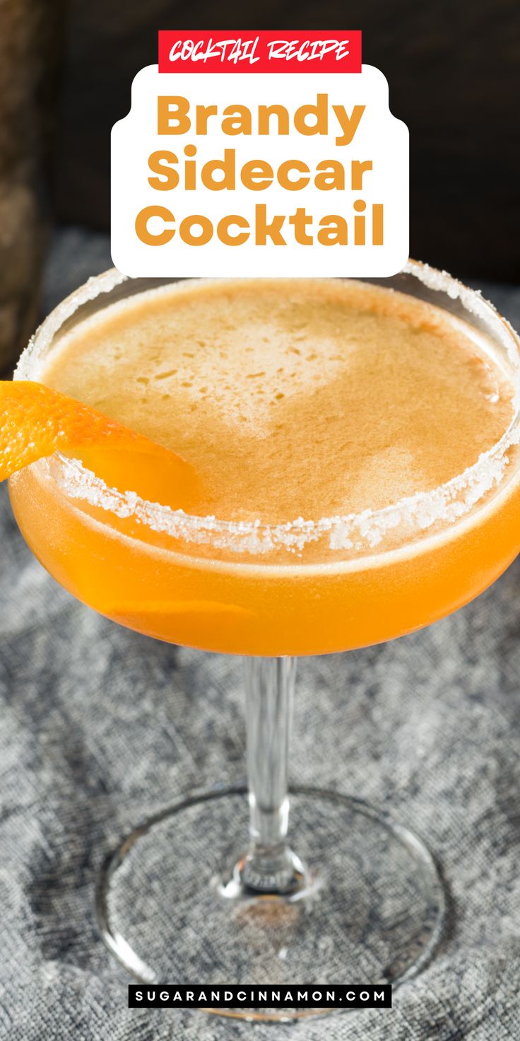 a close up of a drink in a glass with an orange garnish