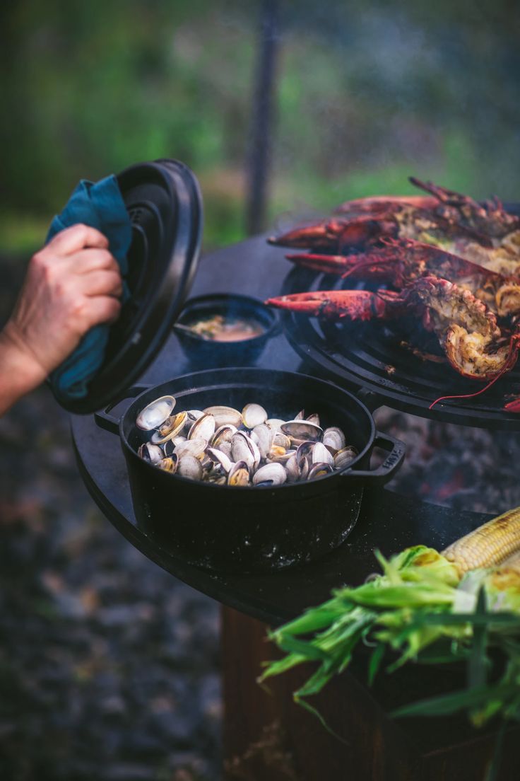 someone is cooking food on an outdoor grill