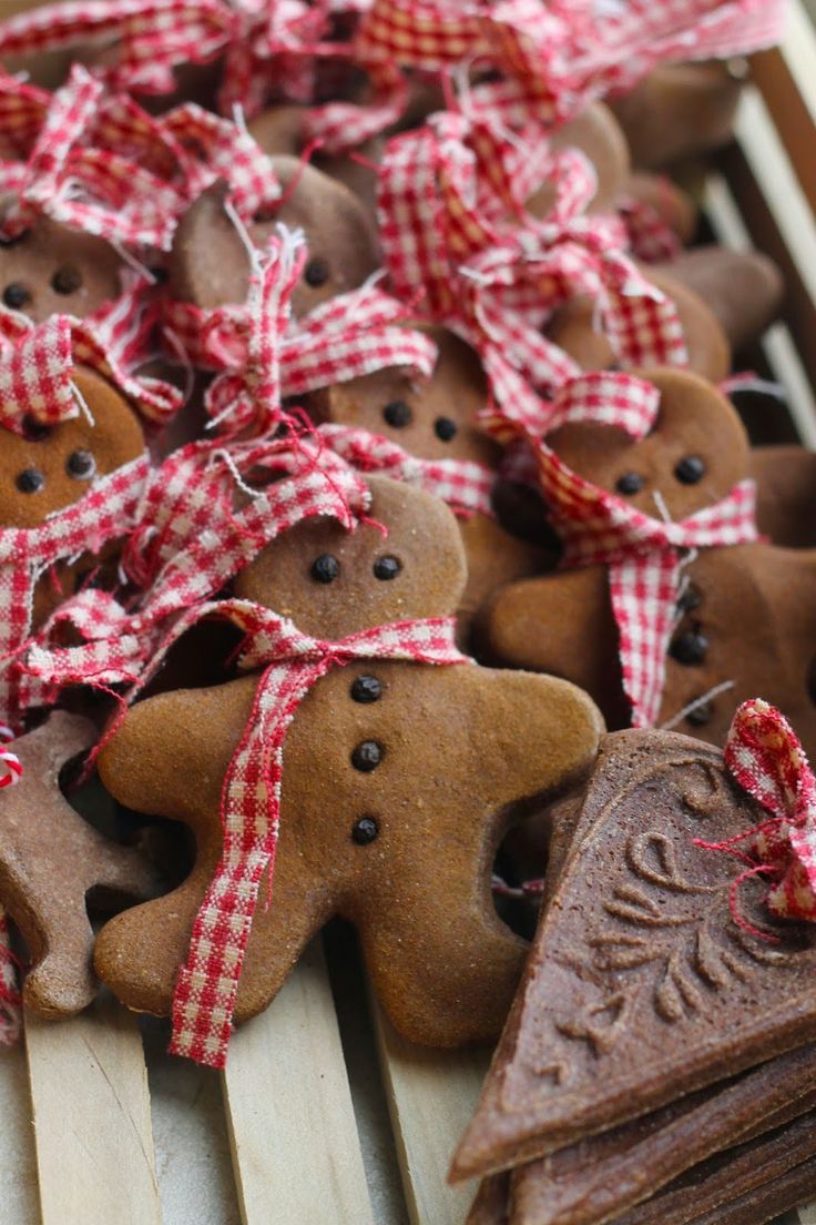 gingerbread cutouts with red and white bows on them