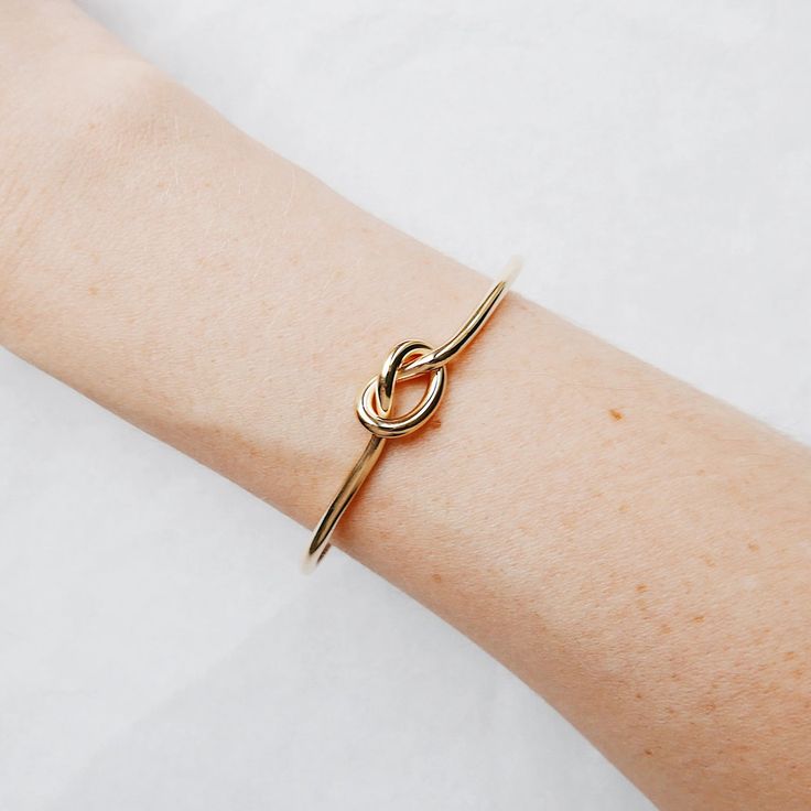 The love knot has been around for quite a bit of time.  Symbolizing an unbreakable bond between two people and an eternal connection.  An effortless piece to wear and a simple reminder of all the love that surrounds you. The perfect gift for a girlfriend, best friend, sister, bridesmaids or even yourself! Free Shipping Love Knot Bracelet, Knot Bracelets, Bracelet Knots, Bangles Jewelry Designs, Knot Bracelet, Gold Bracelet Cuff, Classy Jewelry, More Love, Elegant Bracelet