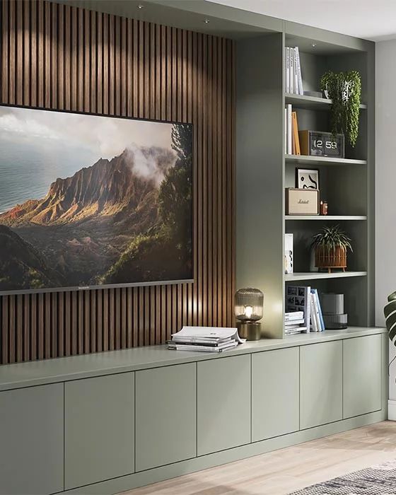 a living room filled with furniture and a painting hanging on the wall above it's bookshelf