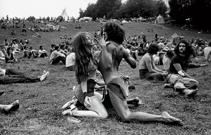 people sitting on the grass at a festival