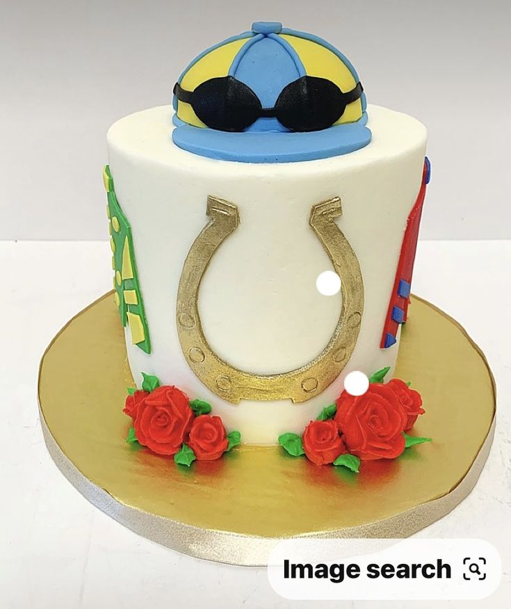 a decorated cake with a horse shoe and sunglasses on top