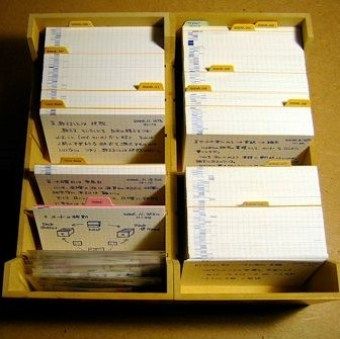 several yellow boxes with papers in them sitting on a table