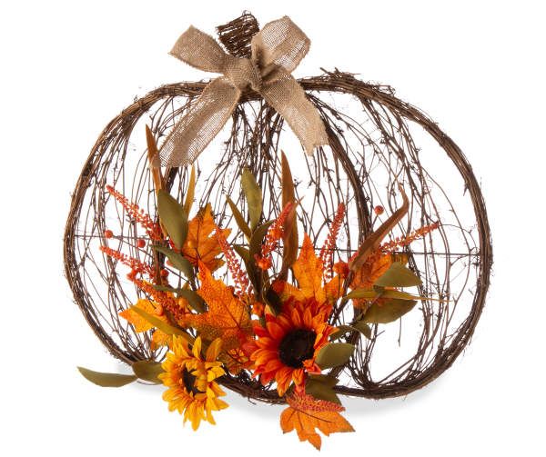 an arrangement of flowers in a pumpkin shaped basket