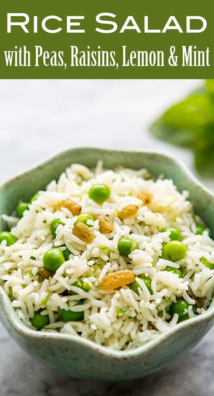 rice salad with peas, raisins, lemon and mint in a green bowl