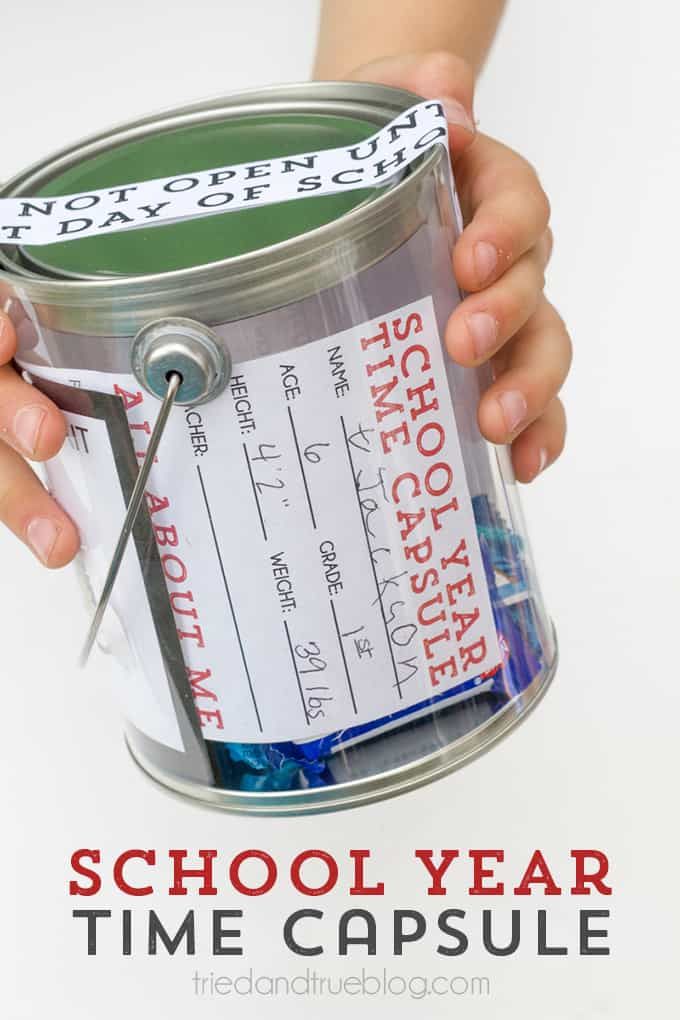 a person holding a bucket with some tickets in it and the words school year time capsule