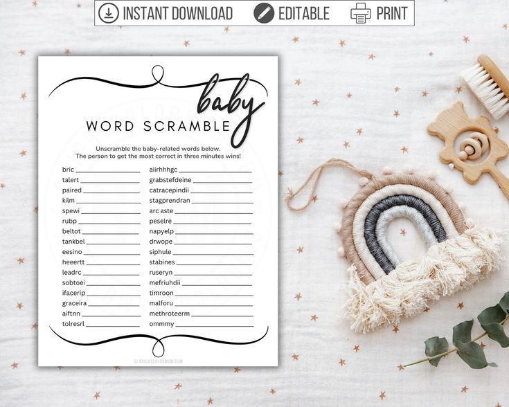 a baby word scramble is displayed on a table with flowers and other items around it