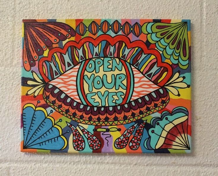 a colorful painting on the wall that says open your eyes with an eyeball in the center