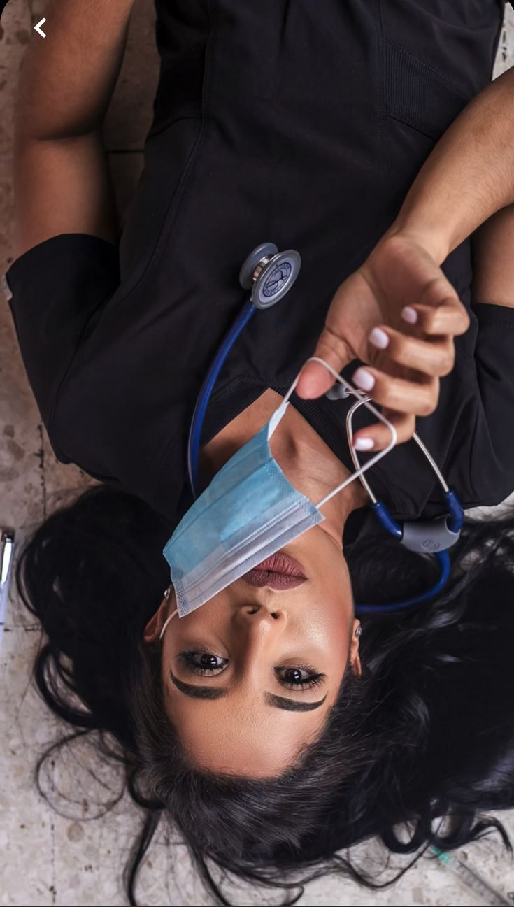 a woman laying on the ground with a stethoscope attached to her head