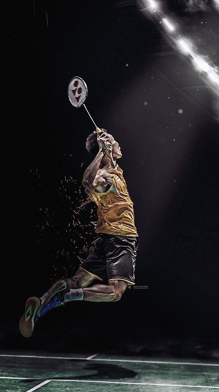 a man jumping in the air with a tennis racket