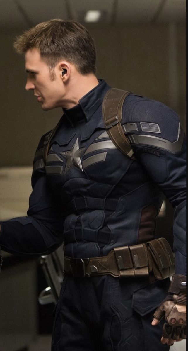 captain america the winter soldier is looking at his cell phone while talking to another man