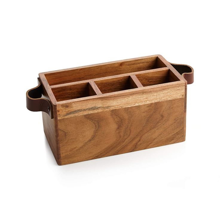 a wooden box with four compartments on it