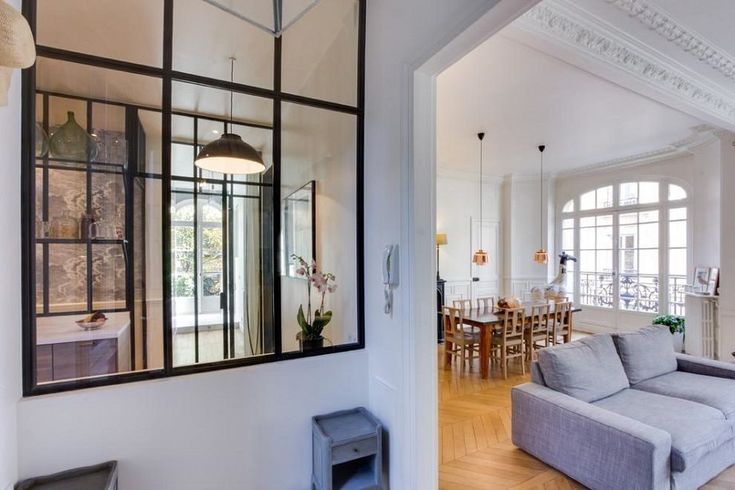 a living room filled with furniture and lots of windows