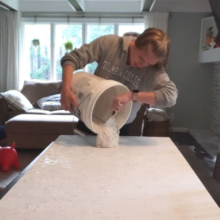 a woman is making something out of paper towels