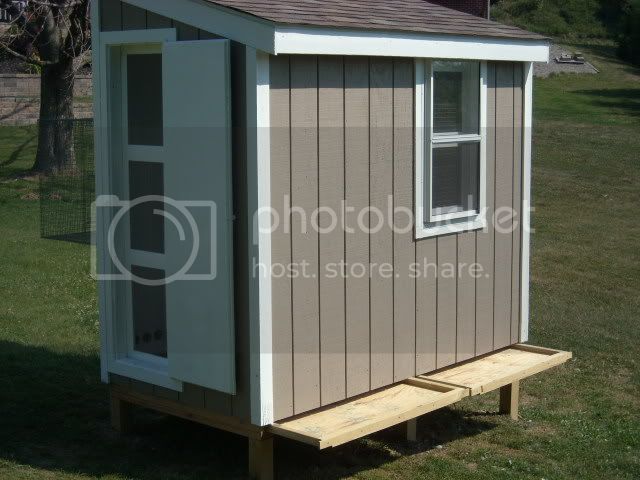 a small shed sitting on top of a lush green field