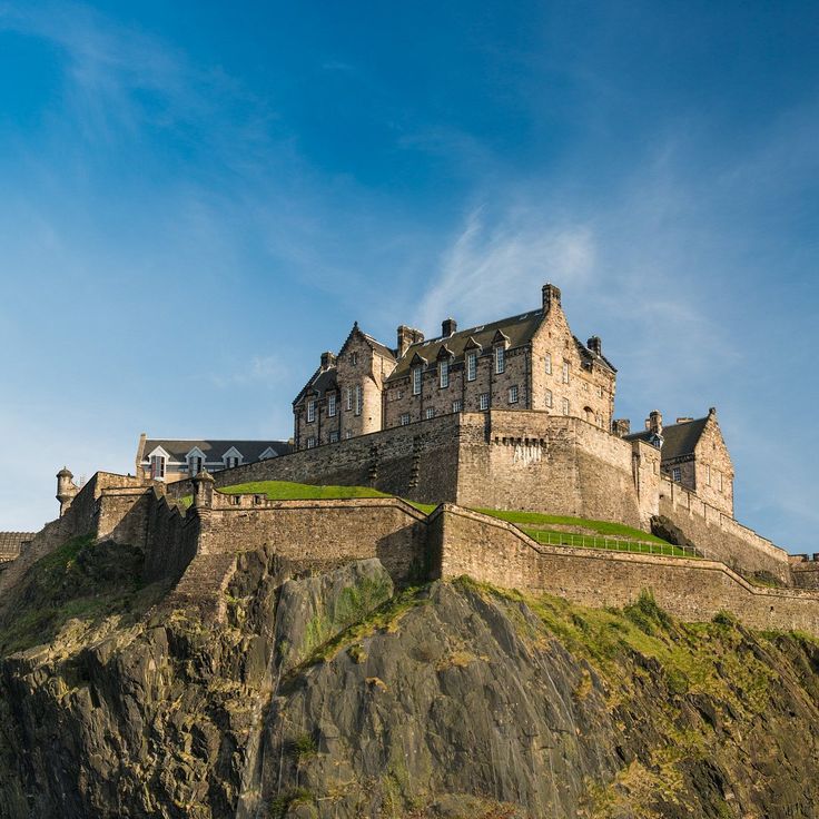 an old castle sitting on top of a cliff