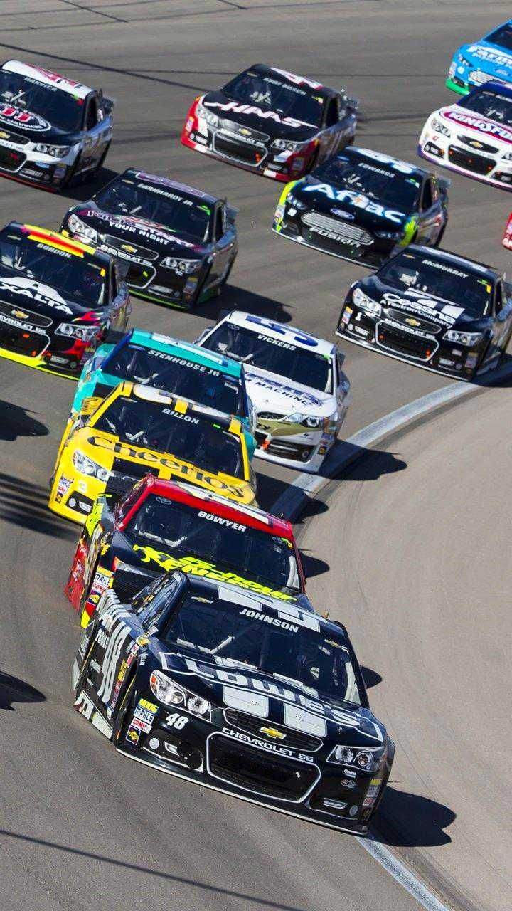 a group of cars driving down a race track