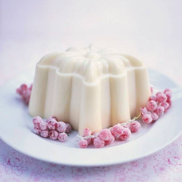 a white plate topped with a cake covered in frosting