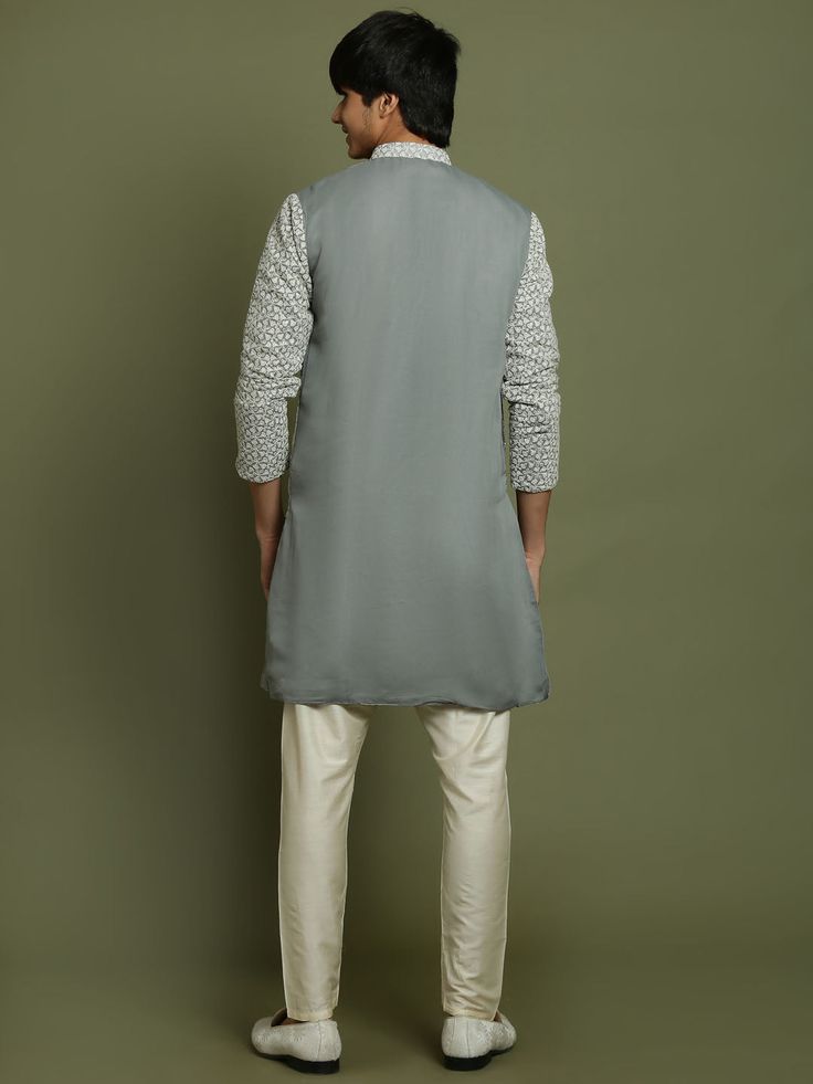 YUVA BY VASTRAMAY Boys' Grey Georgette Chikankari Kurta Pyjama Set This elegant kurta pyjama set features a grey georgette kurta with beautiful chikankari embroidery. The kurta has a mandarin collar, long sleeves, and a button placket. The set comes with matching solid viscose pyjamas for a comfortable and stylish look. Perfect for special occasions or everyday wear. Key Features Grey georgette kurta with chikankari embroidery Mandarin collar Long sleeves Button placket Straight hem with side sl Navratri Cotton Bandhgala, Unstitched Cotton Nehru Jacket For Spring, Cotton Bandhgala With Chikankari Embroidery For Navratri, Cotton Bandhgala Straight Kurta For Transitional Season, Spring Cotton Bandhgala With Dabka, Long Sleeve Cotton Bandhgala For Navratri, Cotton Bandhgala With Dabka For Navratri, Long Sleeve Cotton Nehru Jacket With Dabka, Long Sleeve Cotton Nehru Jacket With Dabka Detailing