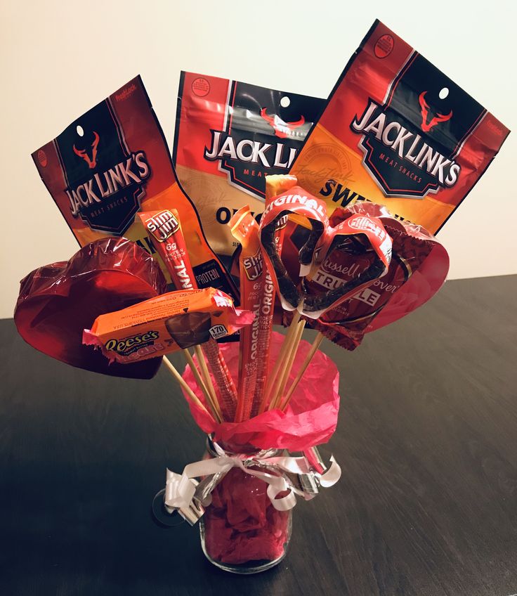 a vase filled with candy and candies on top of a table