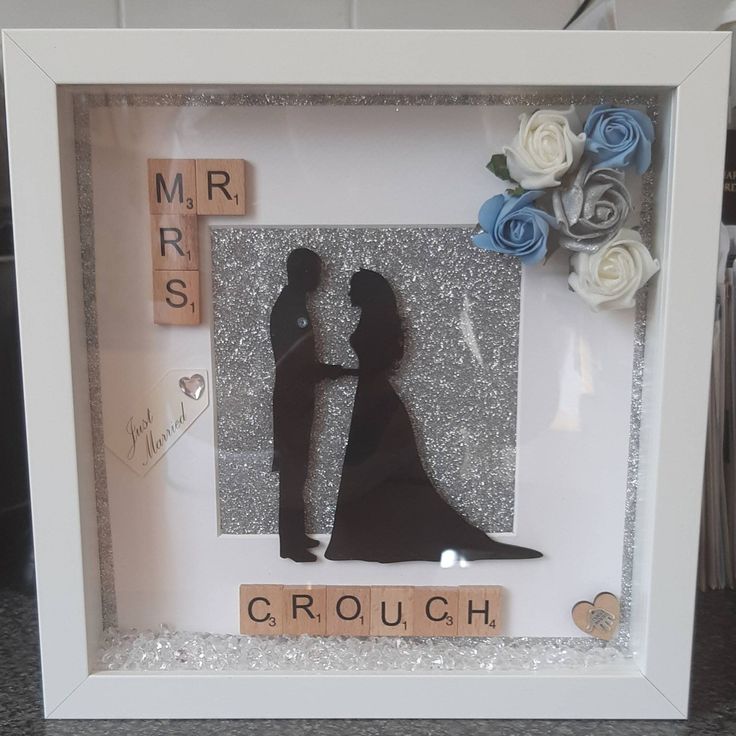 a wedding shadow frame with a bride and groom holding hands