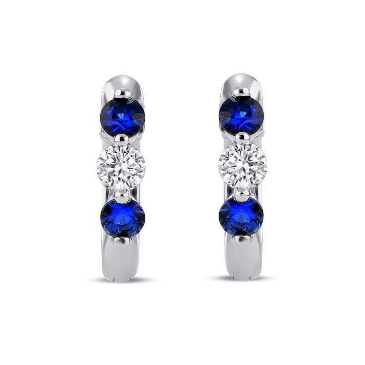 Two vibrant royal blue sapphires rest alongside a sparkling petite diamond in this minimalist and timeless style that can be worn effortlessly for a variety of occasions. Their lightweight nature makes them a comfortable essential that is suitable for styling solo or stacked with other similar huggies. Metal: 18kt Gold Sapphire Weight: 0.40 ct. Diamond Weight: 0.21 ct. Measurements: 12.5 mm drop *Please note that the listed ct. weights are approximate and may be subject to slight variations. Blue Diamond Hoop Earrings Fine Jewelry, Sapphire Diamond Earrings With Accents, Fine Jewelry Sapphire Diamond Earrings, White Sapphire Earrings With Prong Setting, Sapphire Diamond Accented Earrings In Fine Jewelry, Sapphire Earrings In Prong Setting, Diamond White, Fine Jewelry Sapphire Earrings In Diamond White, Anniversary Sapphire Hoop Earrings, White Gold Sapphire Diamond Earrings