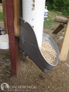 a bird feeder hanging off the side of a wooden fence