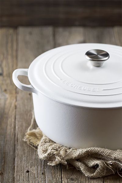 a white casserole dish on a wooden table