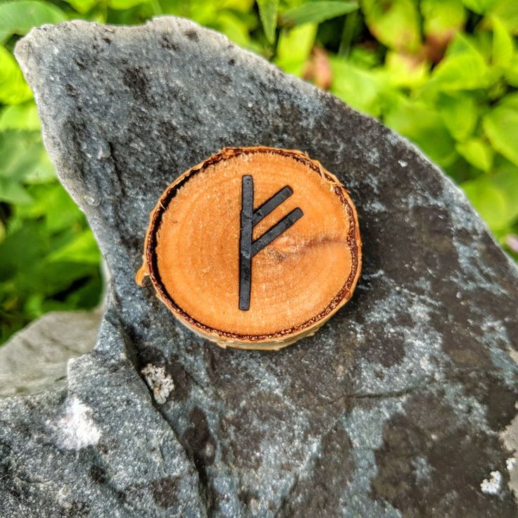 a piece of wood with the letter y carved into it sitting on top of a rock