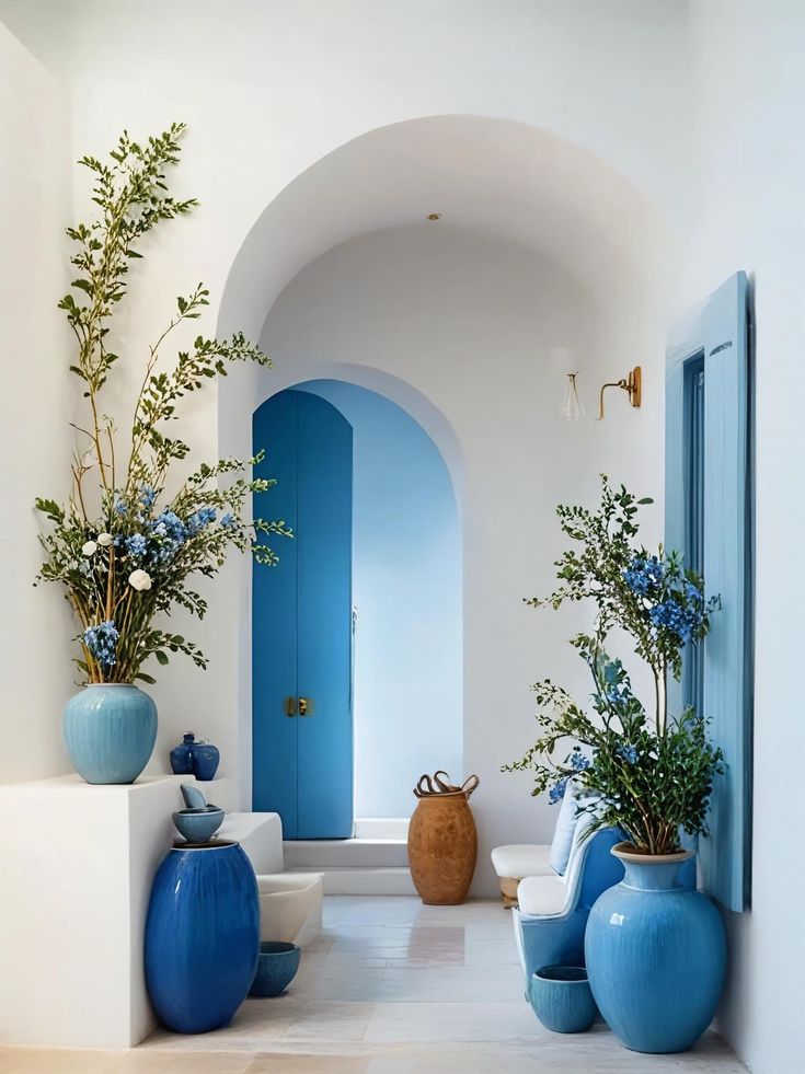 blue and white vases are on the floor in this hallway