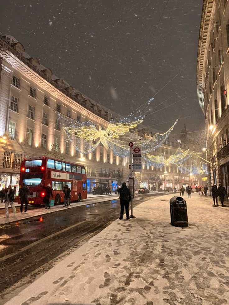 two people standing on the side of a snowy street