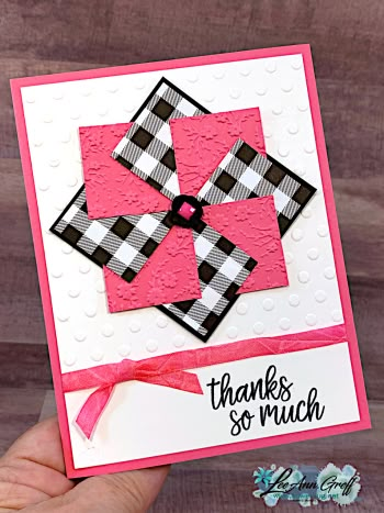 a hand holding up a card with pink and black squares on it, which says thanks so much