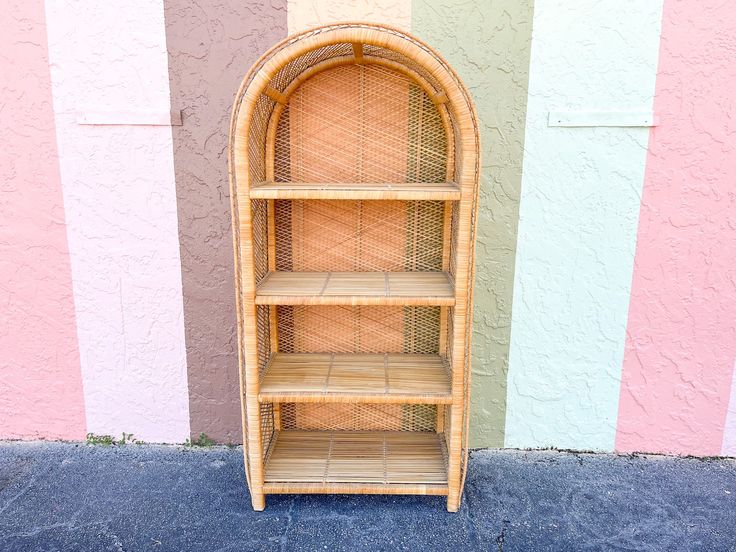 a wooden shelf sitting in front of a wall with pink and blue stripes on it