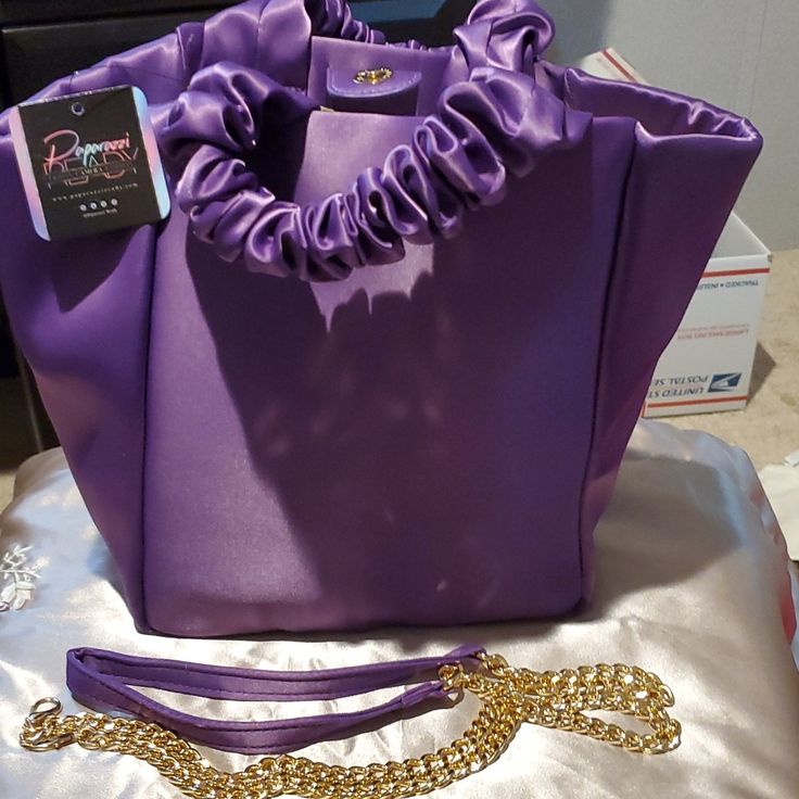 Purple Satin Purse By Paparazzi Has Scrunch Handles And Gold And Purple Satin Removable Strap. 9" By 9" Includes The Paparazzi Dust Bag To Store It In. Purple Bucket Shoulder Bag With Removable Pouch, Purple Shoulder Bucket Bag With Removable Pouch, Purple Party Tote Shoulder Bag, Chic Purple Bucket Shoulder Bag, Chic Purple Evening Bags, Chic Purple Evening Bag, Elegant Purple Evening Bag, Elegant Purple Pouch Shoulder Bag, Purple Shoulder Bucket Bag For Shopping